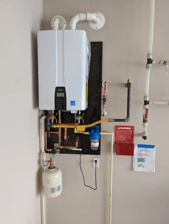 Professional plumber installing copper piping in a Gleneagle home